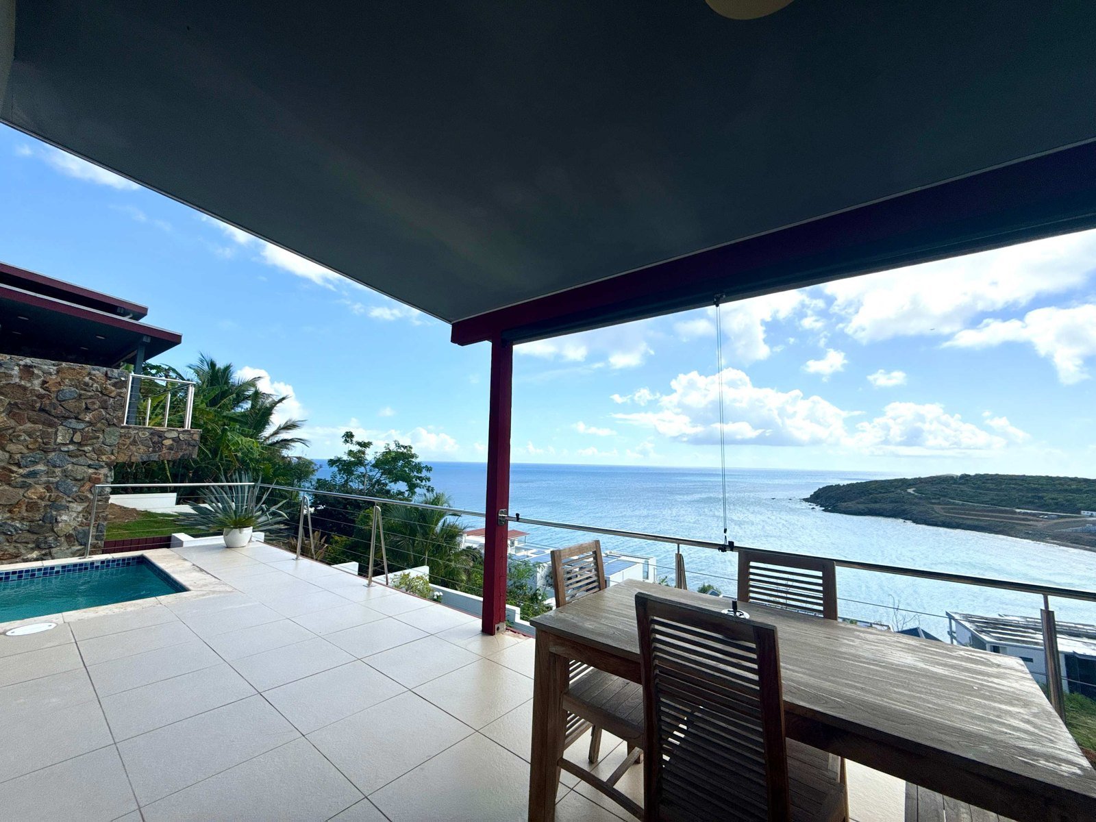 Covered dining terrace and plunge pool looking out over Indigo Bay and the headland, St. Maarten