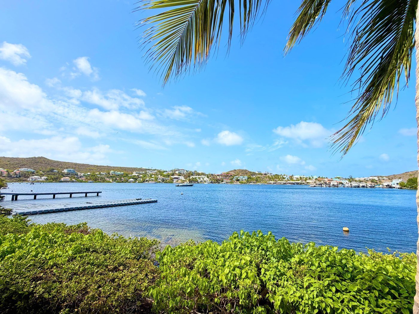 View across Oyster Pond harbour towards marina berths and hillside homes, Sint Maarten